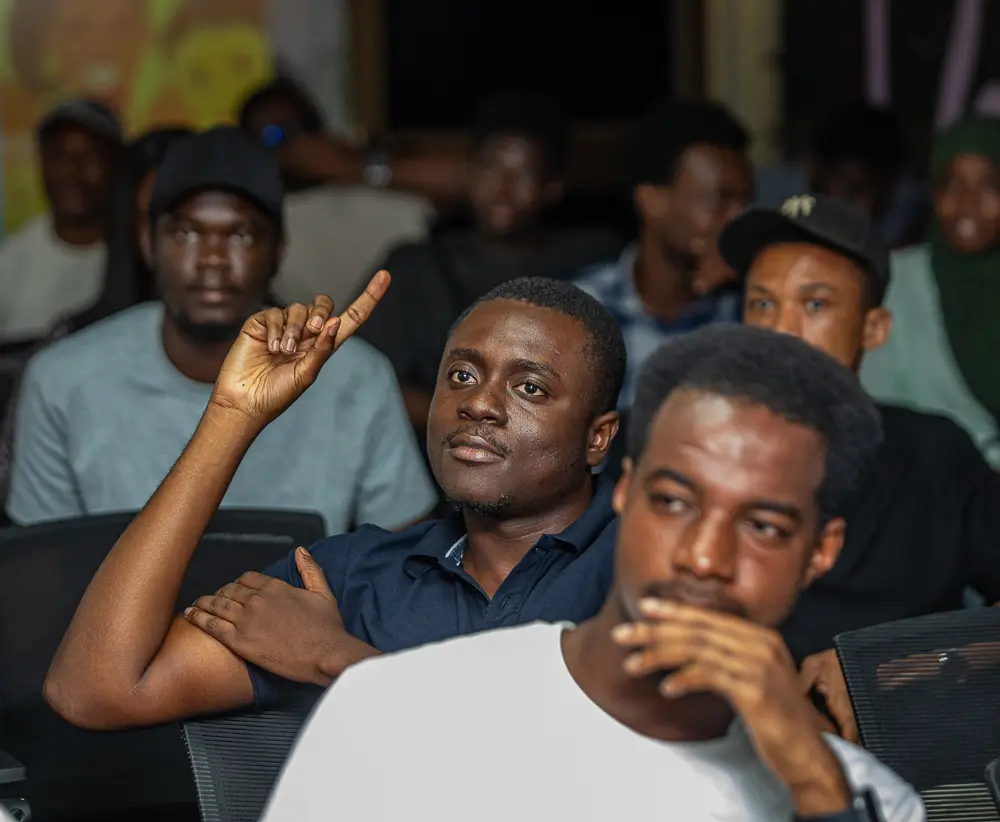 An attendee raising a hand to contribute during the April meetup